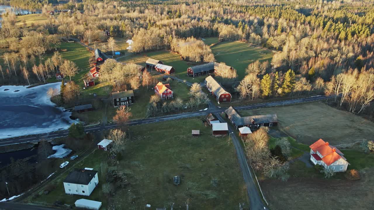 Aerial of a beautiful and remote farms surrounded by forests in rural Sweden