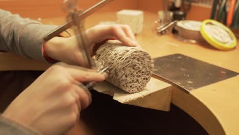 Detail-of-cutting-geopolymer-cylinder-with-string-saw---shot-from-workroom