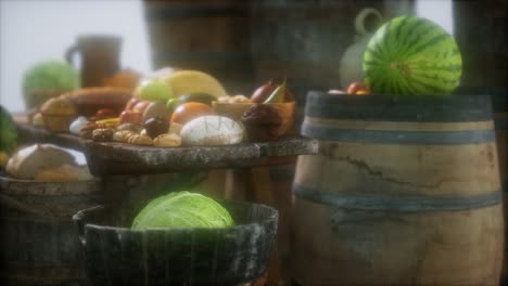 food table with wine barrels and some fruits, vegetables and bread