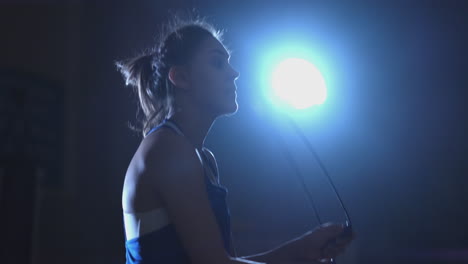 beautiful female boxer jumping rope during active boxing training