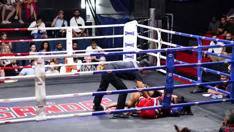 intense muay thai fight in a boxing ring