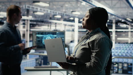 data center admin monitors deep learning process with laptop