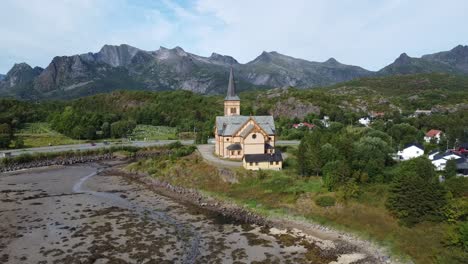 aerial view of a nordic church in lofoten, norway, framed by majestic mountains