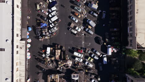 aerial view of a bustling outdoor market and parking lot