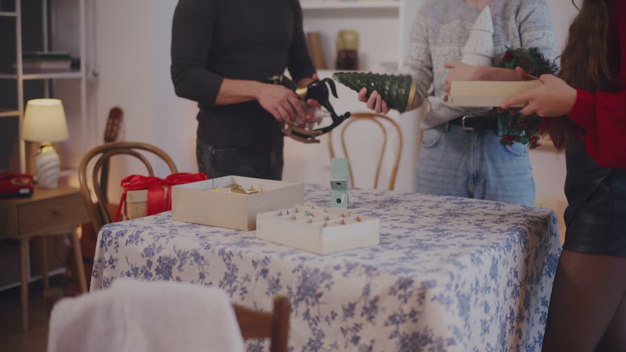 젊은 남자 와 여자 가 크리스마스 장식품 을 놓고 있다