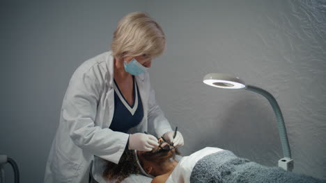 professional dermatologist brushing mask in salon. anti aging skincare routine