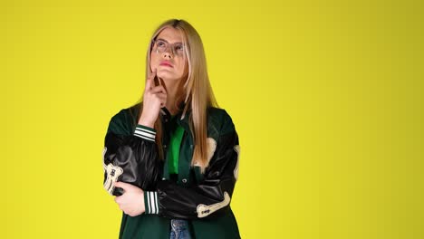 portrait of thoughtful blonde student woman, thinking and uncertain gesture expression, colorful studio shot