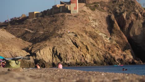 lighthouse at cabo de gata, camera tilting down to reveal the beach nearby
