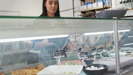 Animation-of-biracial-waitress-taking-food-from-fridge