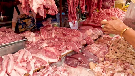 customer choosing meat at a busy butcher shop