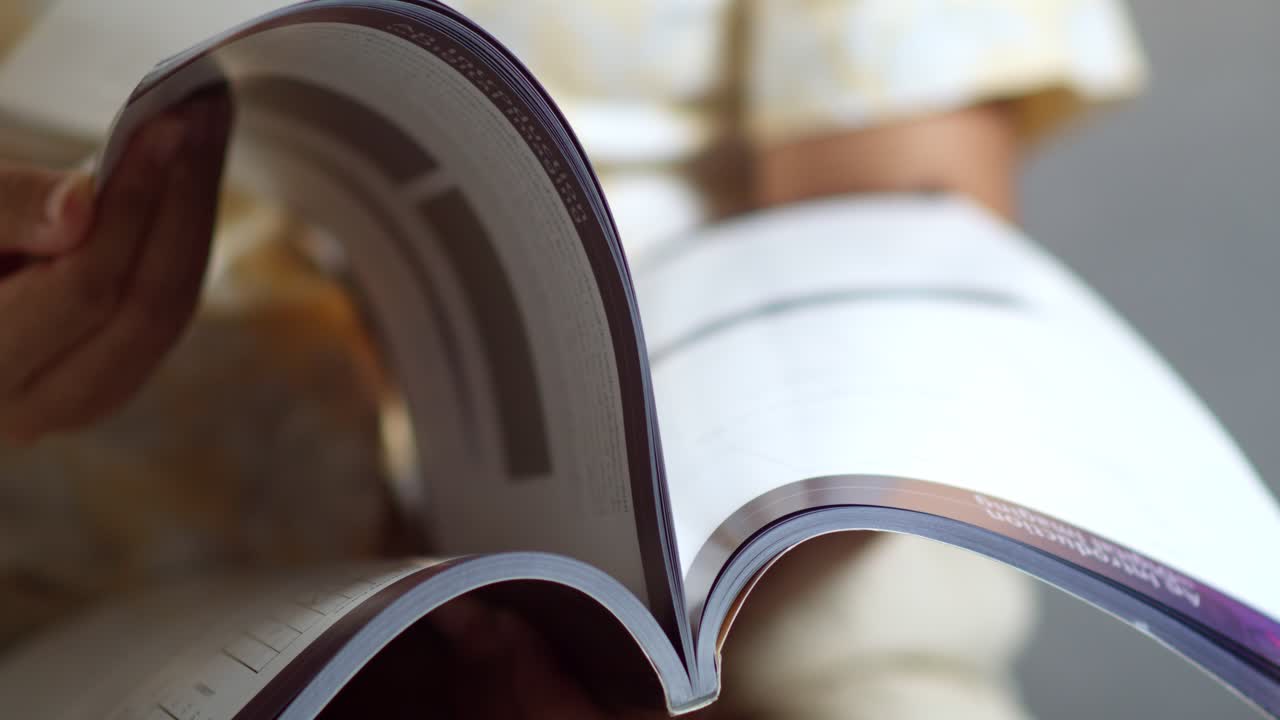 Explore art of flipping through a magazine revealing insightful stories and stunning visuals