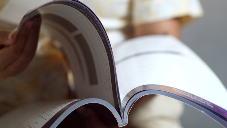 Explore art of flipping through a magazine revealing insightful stories and stunning visuals