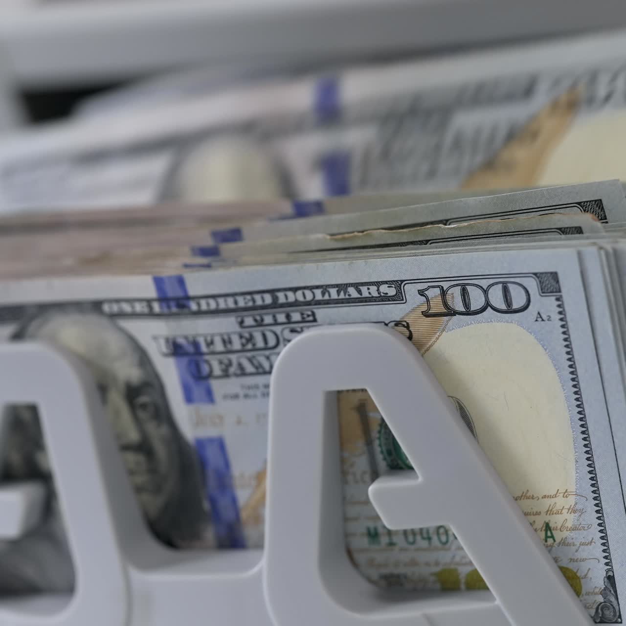 Money counting machine. Banknote counter are counting hundred dollar bills. Close-up