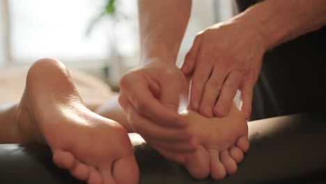 foot massage in spa salon, closeup