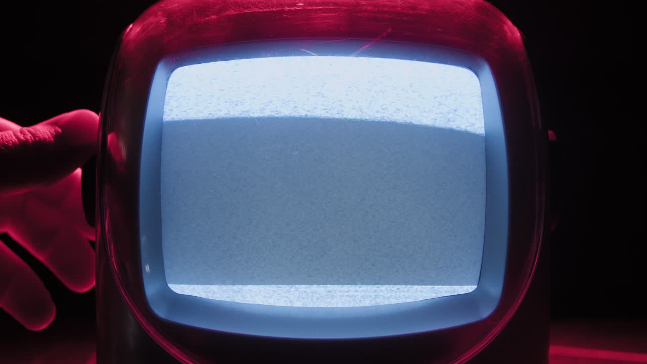 Retro TV, vintage television In a nostalgic setup, a retro TV displays grain on screen, scary halloween night device good for chroma key and green screen. High quality 4k footage