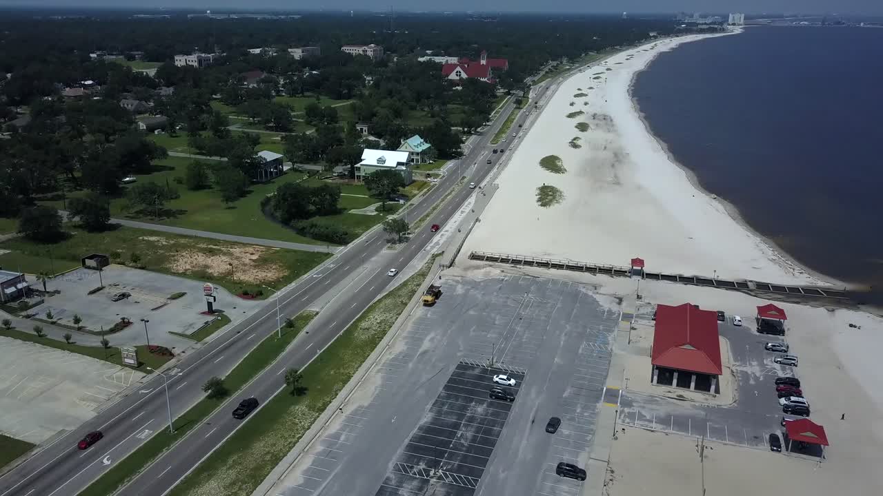 Truck driving off in the distance off the shore in Long Beach, Mississippi.