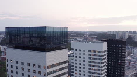 drone footage of high-rise residential buildings with modern design and architecture in årstadal, stockholm