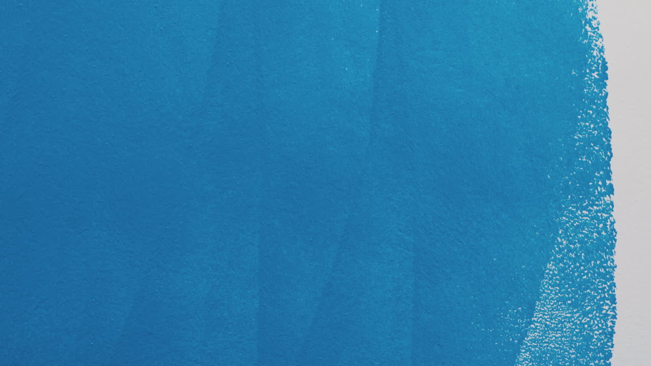 Painting a wall blue with a paint roller