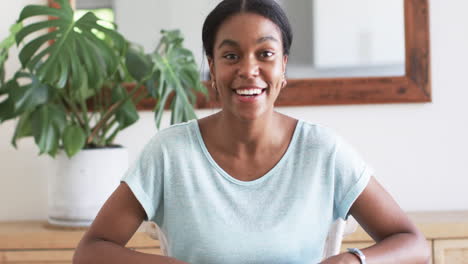 a young african american wife smiles warmly, gesturing during video call