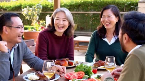 group of asian friends having lunch together outdoors.