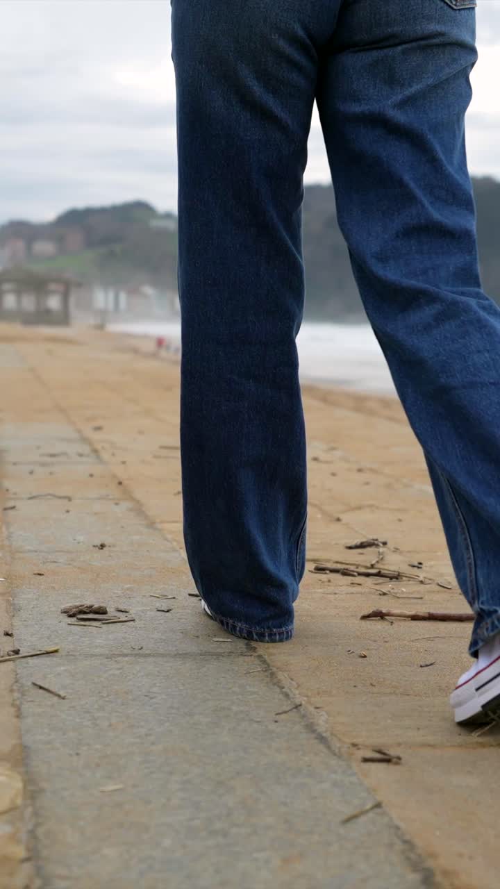 Woman in Jeans Walking on the Beach