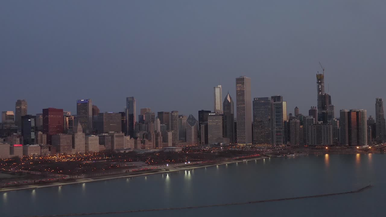 Aerial view of Chicago getting dark from Lake Michigan.