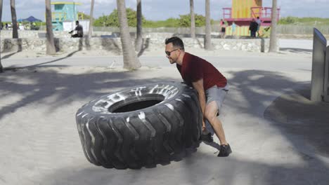 man working out with tyre