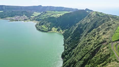 lush green cliffs by the ocean on a sunny day, aerial view