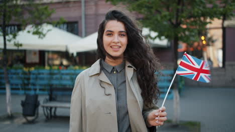woman holding british flag in city street