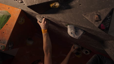 person climbing on a bouldering wall