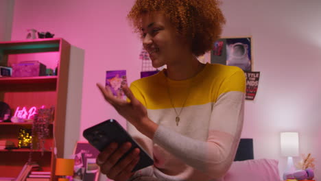 friends looking at a phone in a bedroom