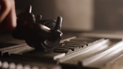 close-up of a person using a metalworking machine