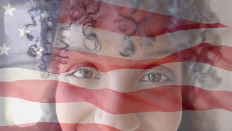 animation of smiling biracial woman over flag of usa