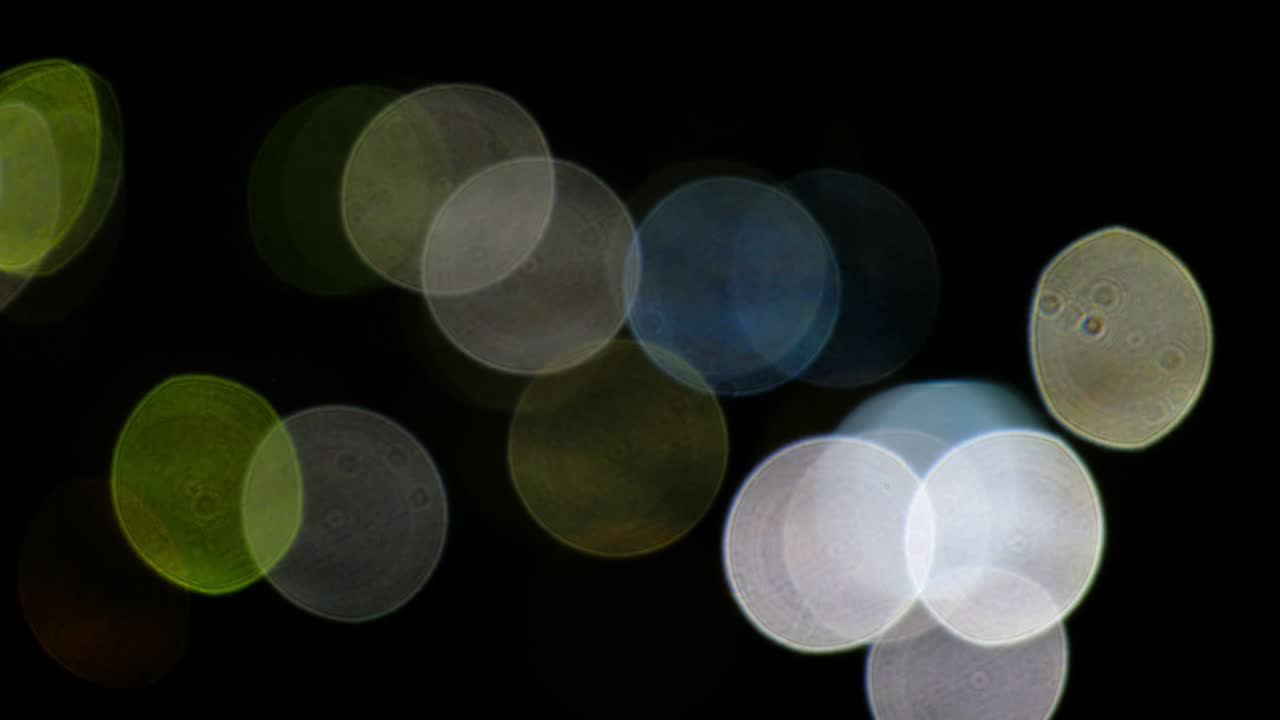 블랙에 빛의 서클의 보케 비디오 배경 렌즈 빛 누출 효과