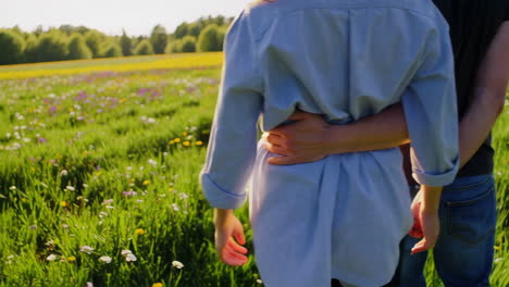 couple walking through a sunny wildflower field