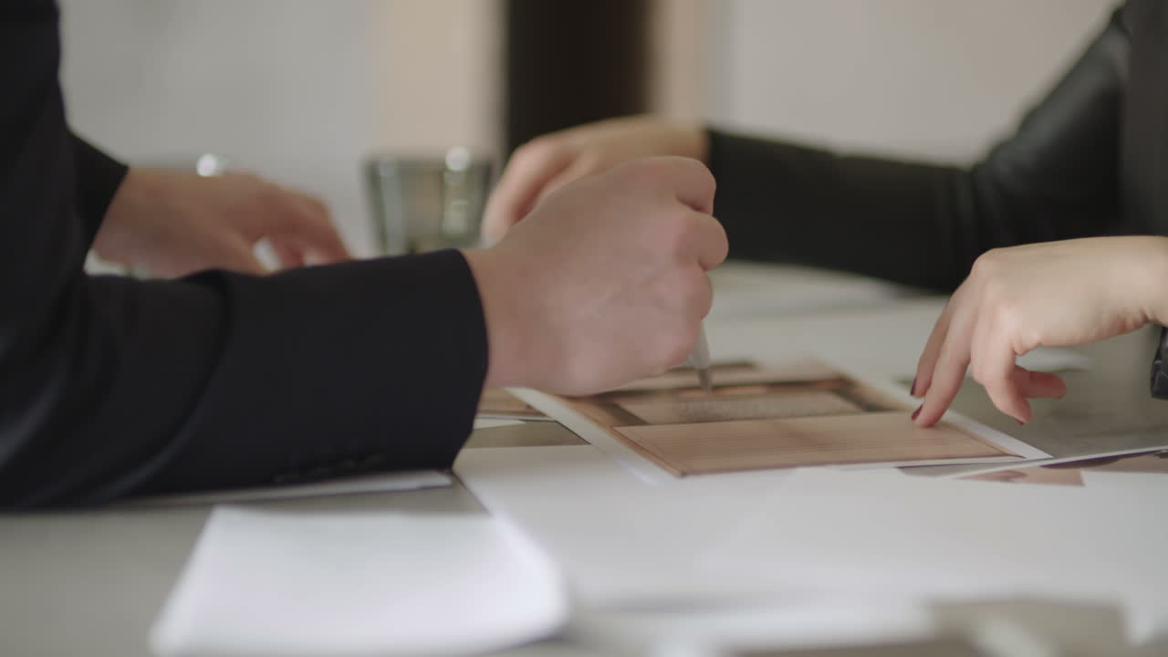 Business People Signing Contracts Together Concluding Deal By Firm Handshake