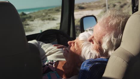 Senior-couple-leaning-together-in-a-car