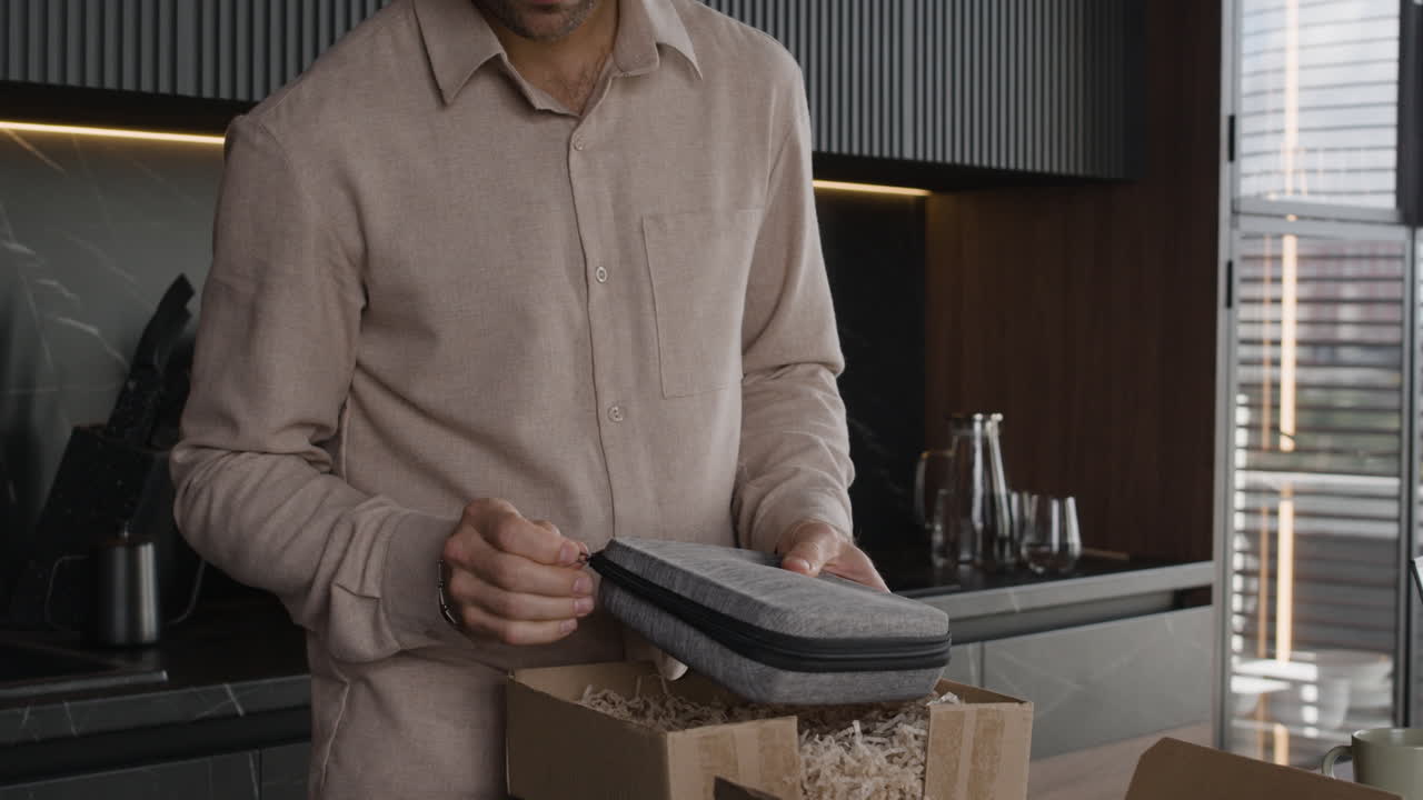 Man unpacking a new product in the kitchen