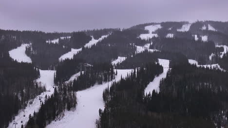 cinematic colorado ski trails zoomed in gondola ski lifts aerial drone cloudy snowy winter december christmas keystone ski resort epic local pass entrance rocky mountain breckenridge vail circle left