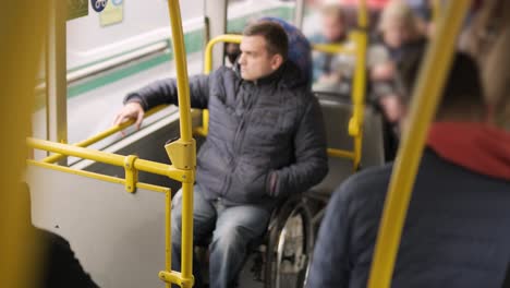 person with a physical disability inside public transport with an accessible ramp