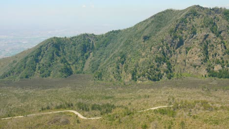 Panning-across-the-surroundings,-mountains-and-cliffs-of-the-Mount-Vesuvius-volcano-near-Pompeii,-Italy