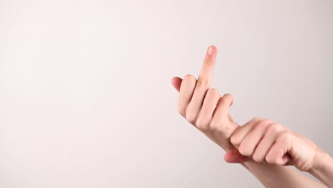 hand gesture of reeling in a middle finger on a white background