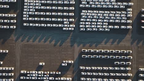 aerial top down descend over parking lot with identical cars