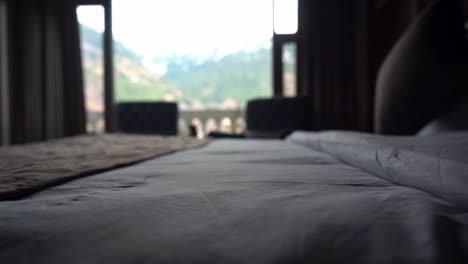 A-Cozy-Hotel's-Bedroom-With-View-Of-Mountain-Ridges-Outside-At-Early-Morning