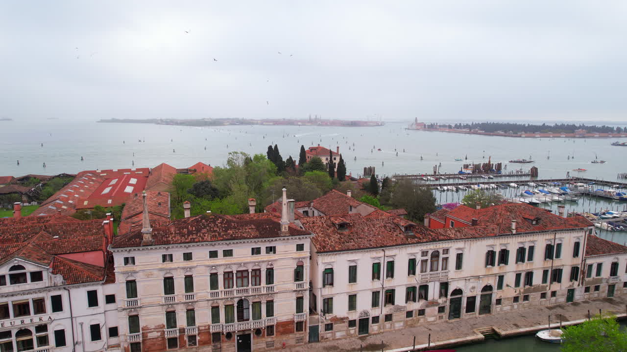 Aerial drone shot of Italian building facade with Murano island in background