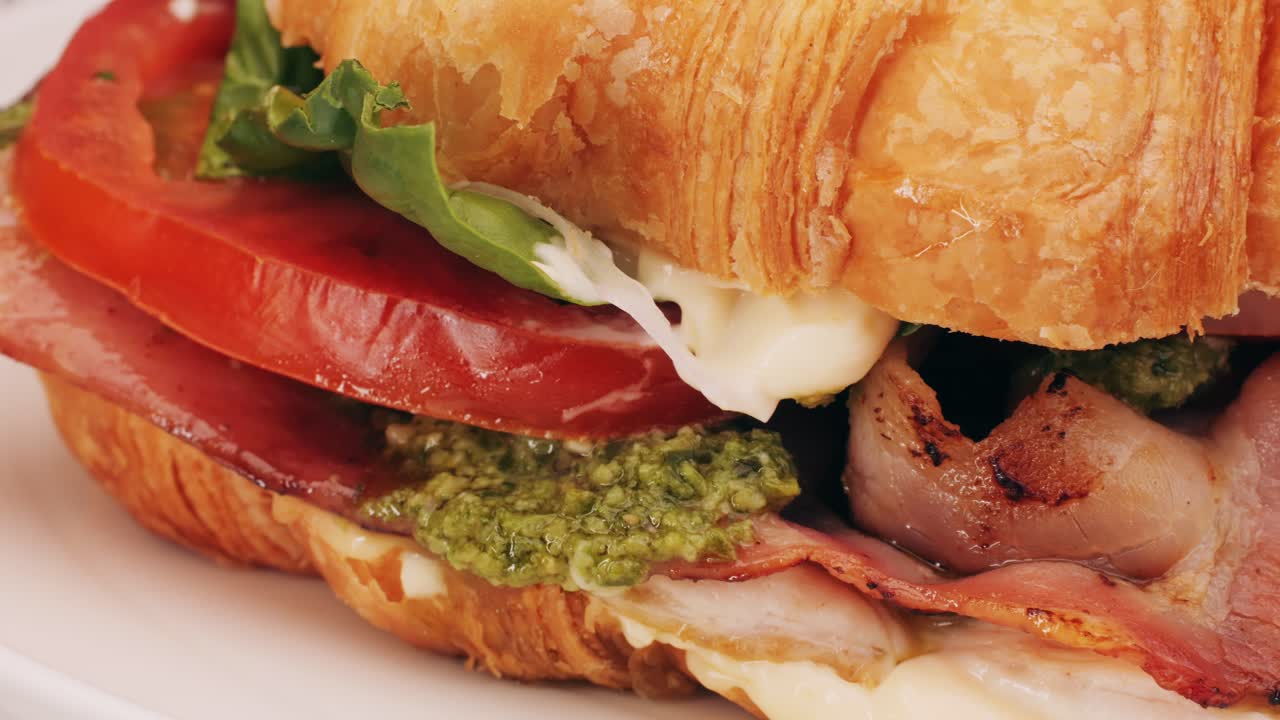 Croissant with jamon ham, Salmon, in Modern Cafe, Top View of Healthy Breakfast in Cafe. English breakfast: fried egg, bacon toast on sandwich.