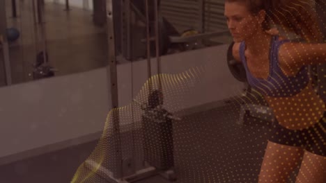 animation of moving spots over fit woman exercising in gym