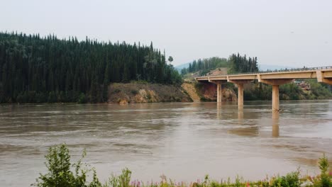 Alaska-Highway---Fast-flowing-Tanana-river-in-Alaska-and-bridge---low-angle-aerial-flyover-shot