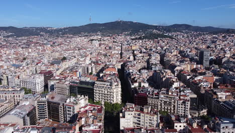 aerial flying forward over barcelona city on sunny day, spain