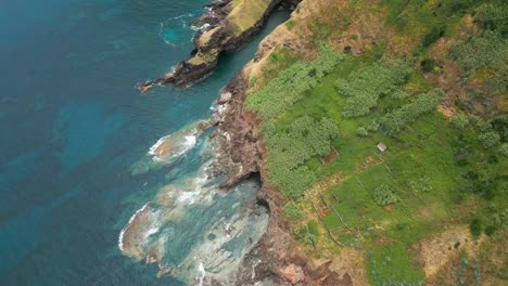 aerial view of santa maria island's rugged coast and lush fields, azores